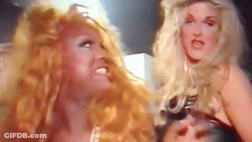 Two Women With Long Red Hair Are Standing Next To Each Other And Making Funny Faces . GIF