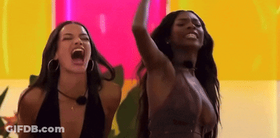 Two Women With Open Mouths And Raised Arms GIF