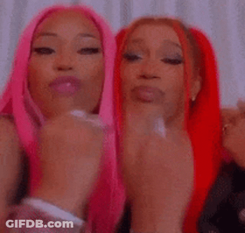 Two Women With Pink And Red Hair Covering Mouths GIF