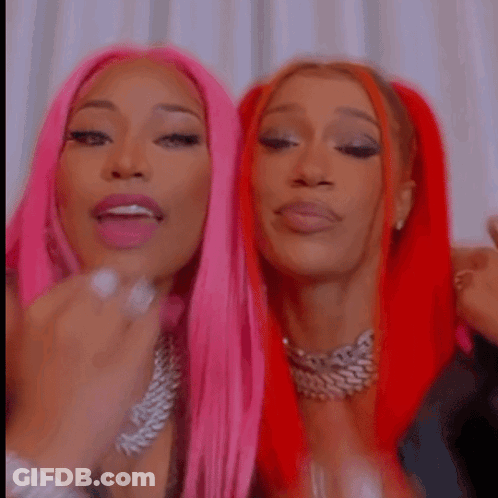 Two Women With Pink And Red Hair Posing GIF