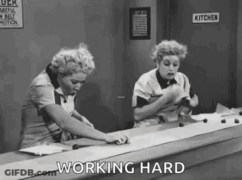 Two Women Working On Conveyor Belt GIF