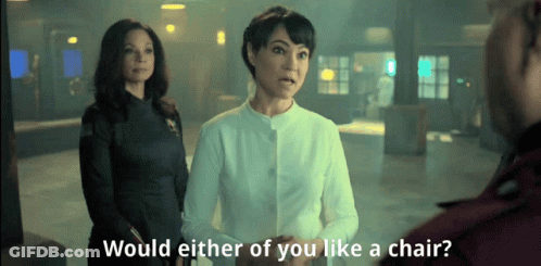 Two Women Would Either Of You Like Chair GIF
