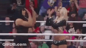 Two Women Wrestling In A Ring Holding Hands GIF