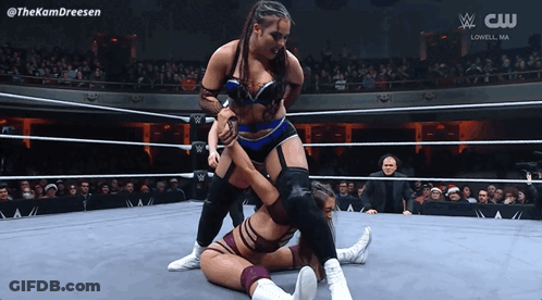 Two Women Wrestling In Ring With CW Logo GIF