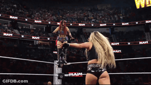 Two Women Wrestling In Ring With RAW On Wall GIF