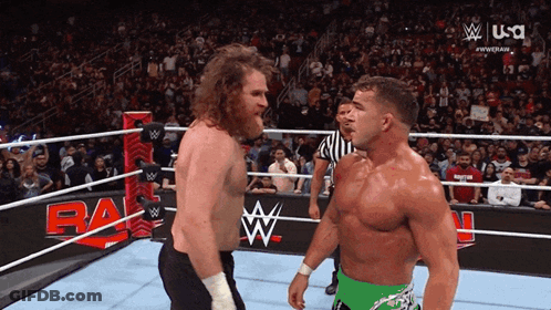 Two Wrestlers Are Facing Each Other In A Wrestling Ring With A USA Logo Behind Them GIF