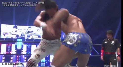 Two Wrestlers Are Fighting In A Ring With A Referee Watching GIF