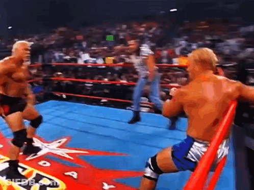 Two Wrestlers Are Fighting In A Ring With A Star On The Floor . GIF