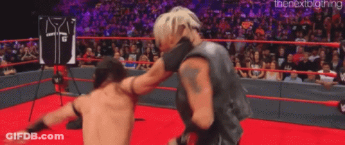 Two Wrestlers Are Fighting In A Wrestling Ring . GIF