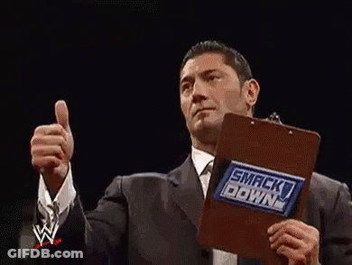Two Wrestlers Are Giving A Thumbs Up In A Wrestling Ring . GIF