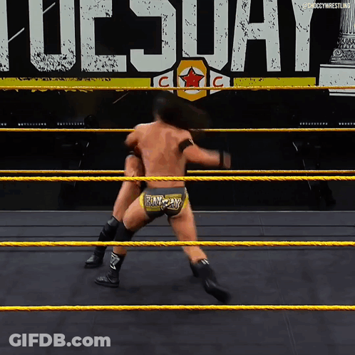 Two Wrestlers Are In A Ring With The Word Tuesday In The Background GIF
