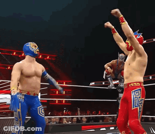Two Wrestlers Are In A Wrestling Ring And One Has The Letter G On His Shorts GIF