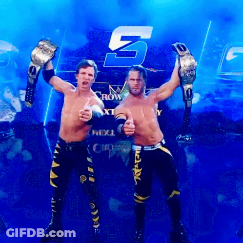 Two Wrestlers Are Posing In Front Of A Sign That Says Next GIF