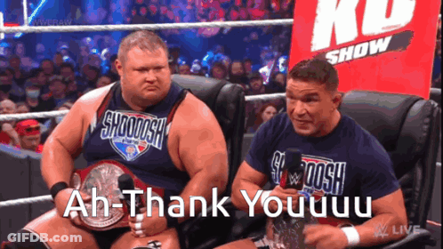 Two Wrestlers Are Sitting In Front Of A Crowd And One Of Them Says Ah-Thank Youuuu GIF