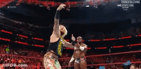 Two Wrestlers Are Standing In A Ring During A Match . GIF