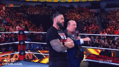 Two Wrestlers Are Standing In A Wrestling Ring And One Has A Shirt That Says Life Is Me GIF