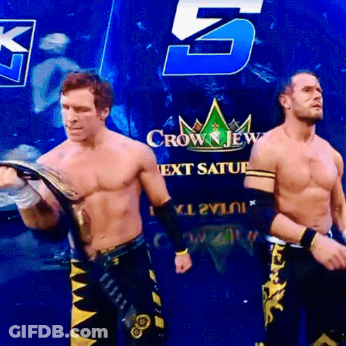 Two Wrestlers Are Standing In Front Of A Crown Jew Next Saturday Sign GIF