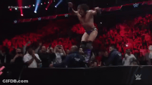 Two Wrestlers Are Wrestling In A Ring With A W Netwo Banner In The Background GIF