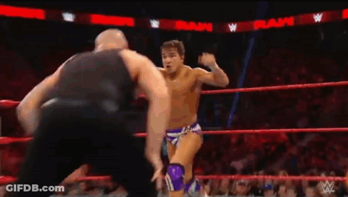 Two Wrestlers Fighting In Ring With Referee GIF