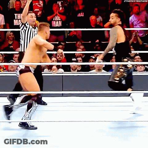 Two Wrestlers Fighting In Ring With Referee GIF