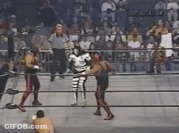 Two Wrestlers Fighting In Ring With Referee GIF