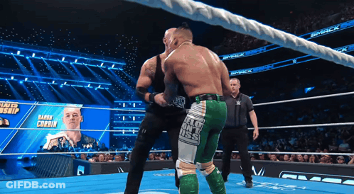 Two Wrestlers Fighting In Ring With Smack Banner GIF
