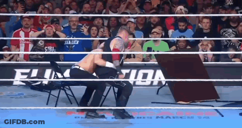 Two Wrestlers Fighting In Ring With Table GIF