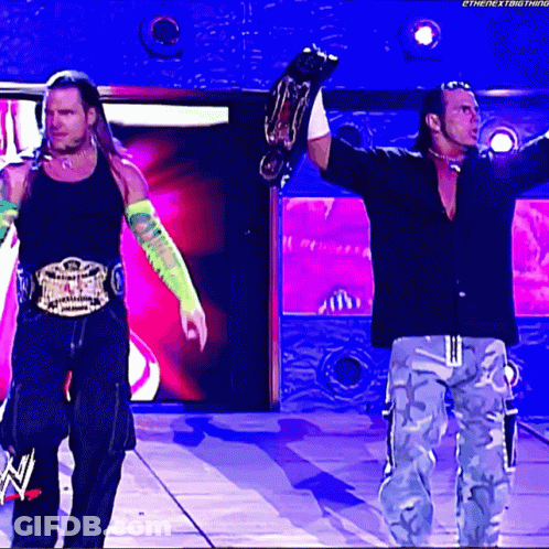 Two Wrestlers Holding Championship Belts Next Thing GIF
