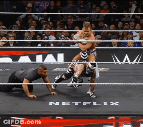 Two Wrestlers In A Ring With A Netflix Logo In The Background GIF