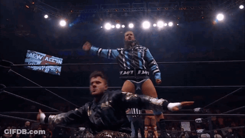 Two Wrestlers In A Ring With A Sign That Says Aew All In On It GIF