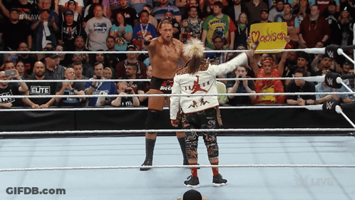 Two Wrestlers In A Ring With A Sign That Says Madison On It GIF