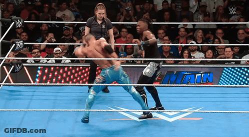 Two Wrestlers In A Wrestling Ring With A Sign That Says Main On It GIF