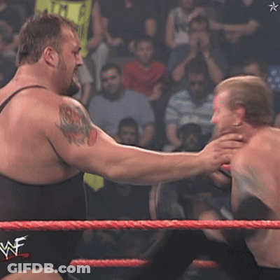 Two Wrestlers In A Wrestling Ring With A Wwe Logo On The Ropes GIF
