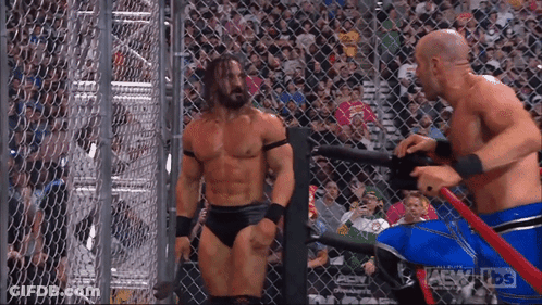Two Wrestlers In Cage With AEW Crowd GIF