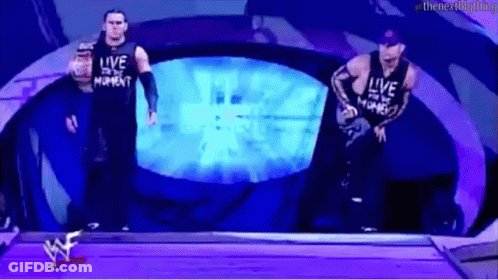 Two Wrestlers In Front Of Live Screen GIF
