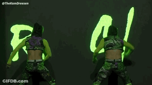 Two Wrestlers In Front Of Neon Sign Saying RS / IL GIF