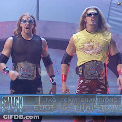 Two Wrestlers In Front Of SmackDown Sign GIF