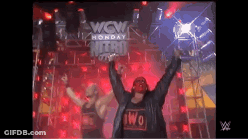 Two Wrestlers In Front Of Wow Monday Nitro Sign GIF