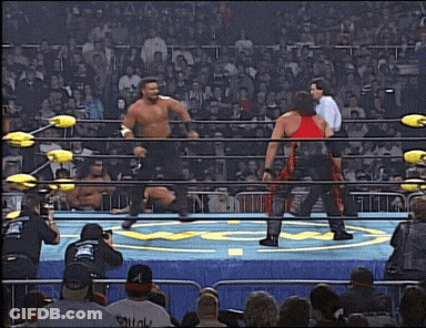 Two Wrestlers In Ring One Wearing Squat Shirt GIF