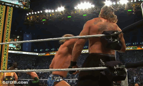 Two Wrestlers In Ring With Koya Sign GIF
