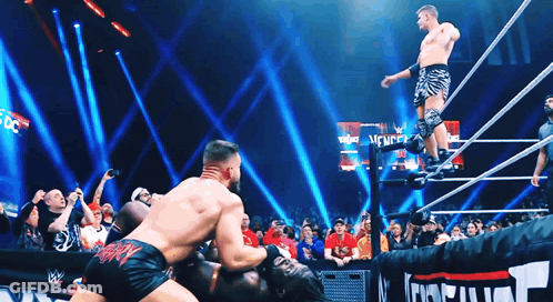 Two Wrestlers In Ring With New York Sign GIF