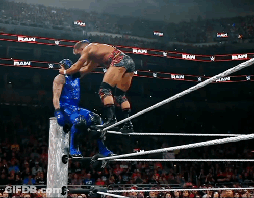 Two Wrestlers In Ring With Raw Behind Them GIF