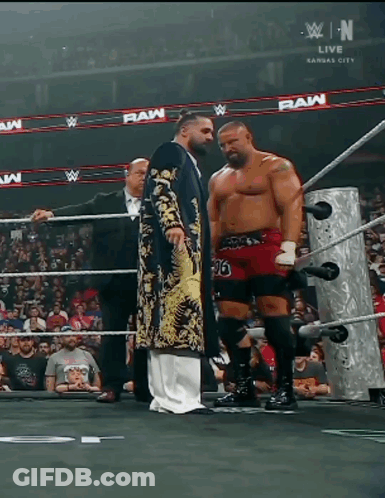Two Wrestlers In Ring With Raw GIF