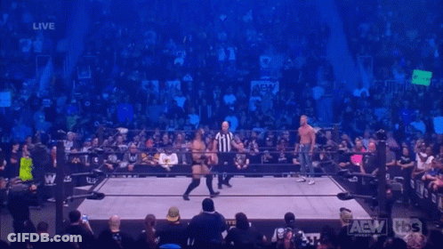 Two Wrestlers In Ring With Referee GIF