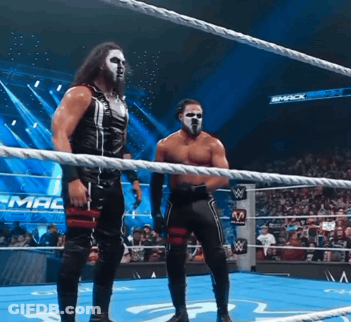 Two Wrestlers In Ring With Smack Down Sign GIF