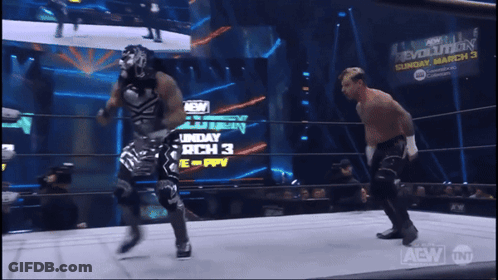 Two Wrestlers In Ring With Sunday March 3 Sign GIF