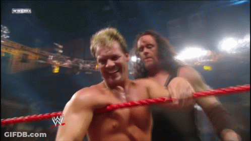 Two Wrestlers In Ring With W Logo GIF