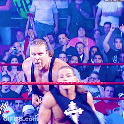 Two Wrestlers In Ring With W Logo GIF