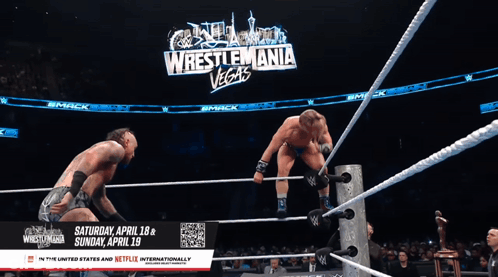 Two Wrestlers In Ring With Wrestlemania Vegas Sign GIF