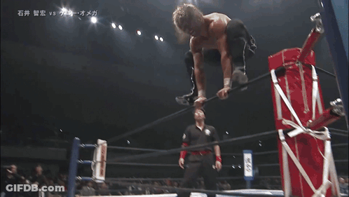 Two Wrestlers Laying On Floor With Chinese Writing GIF